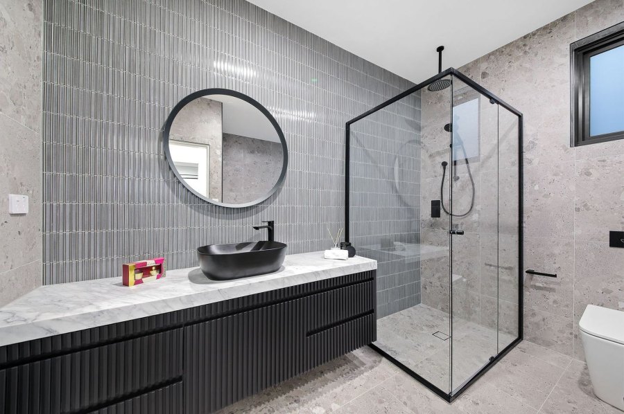 Contemporary bathroom with black sink and shower