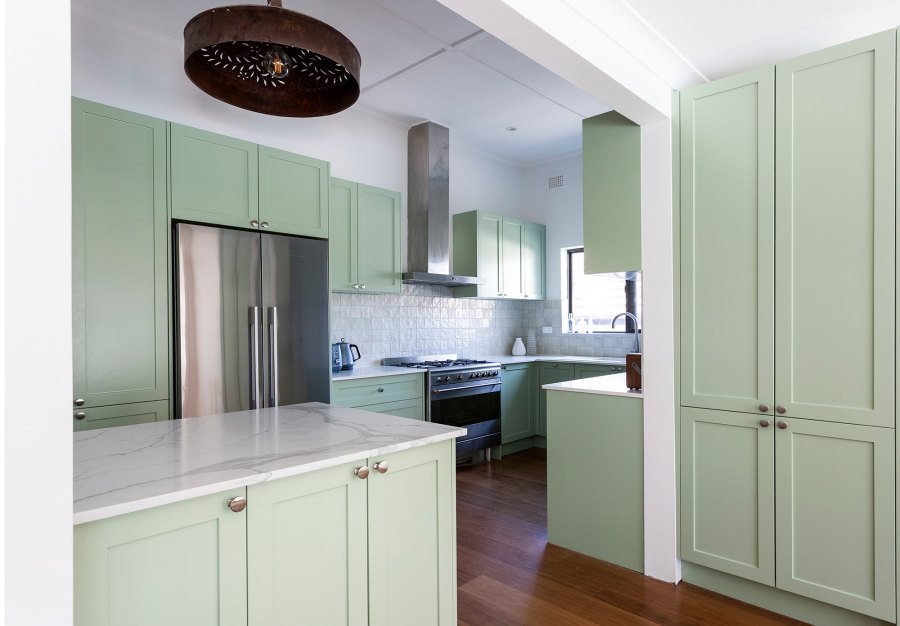 Modern kitchen with green cabinets and island