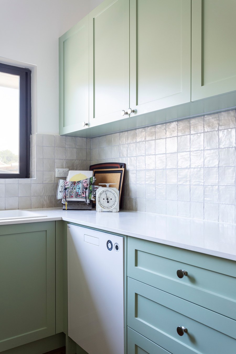 Light green kitchen cabinets with backsplash