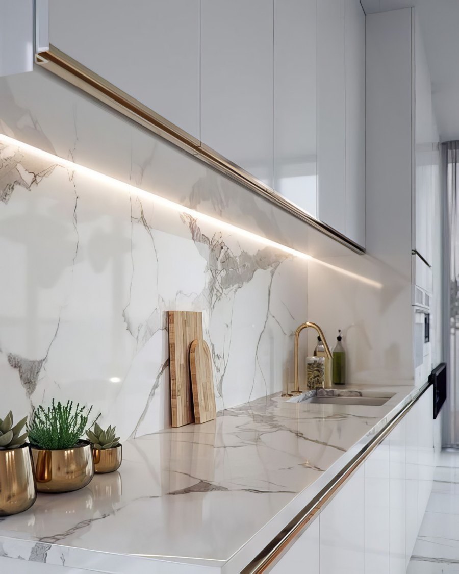 Modern kitchen with marble backsplash and lighting