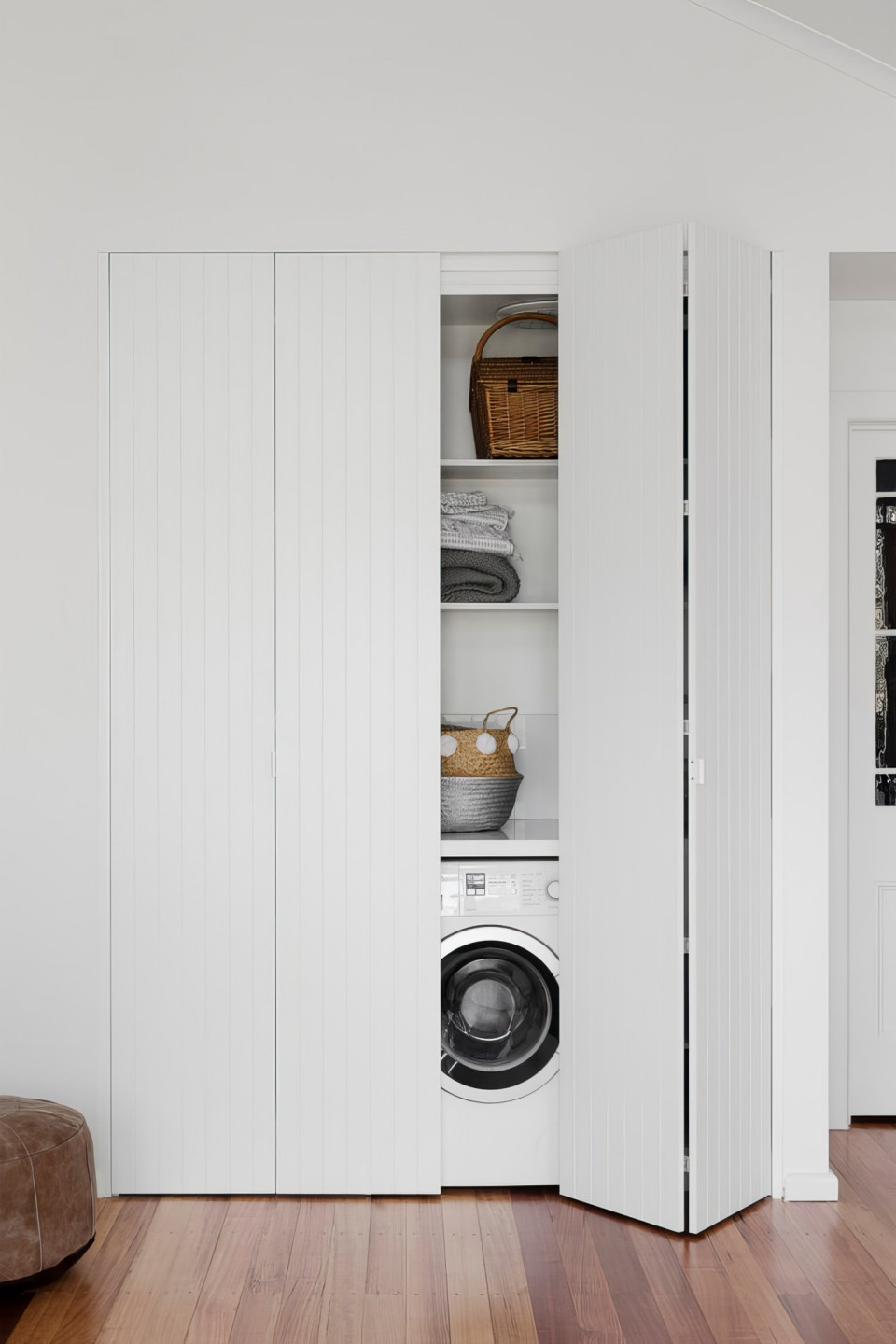 Modern laundry room with minimalist design and under-cabinet lighting