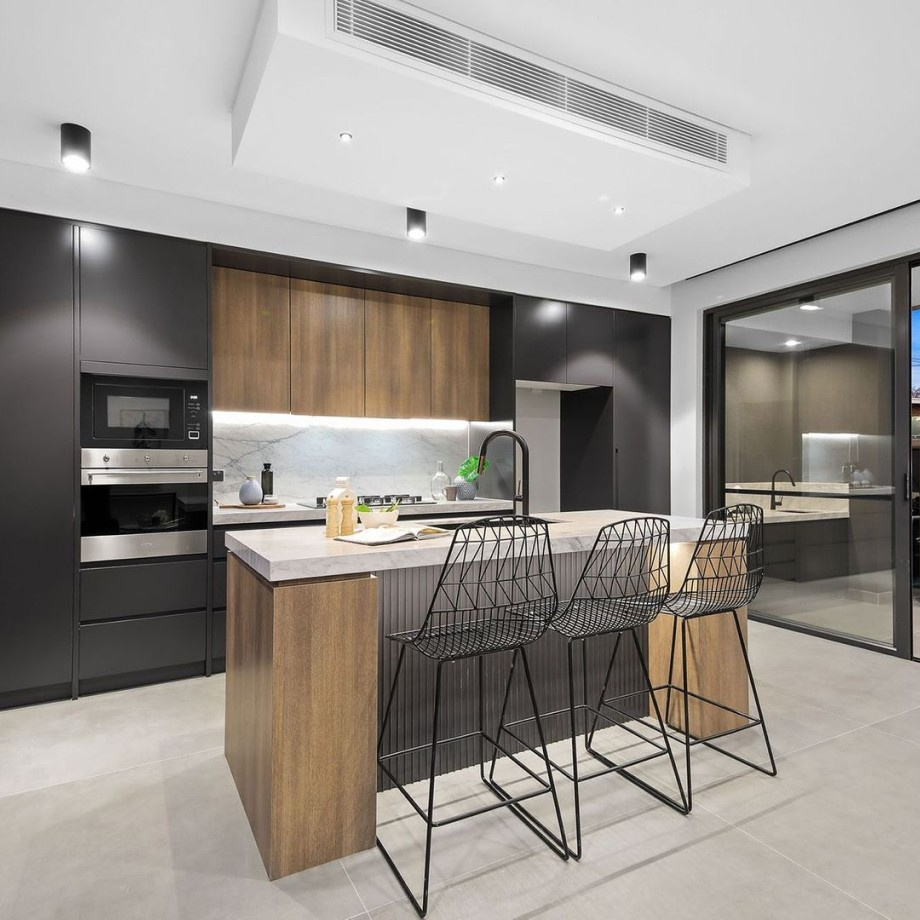 Modern kitchen renovation with island and sleek cabinetry