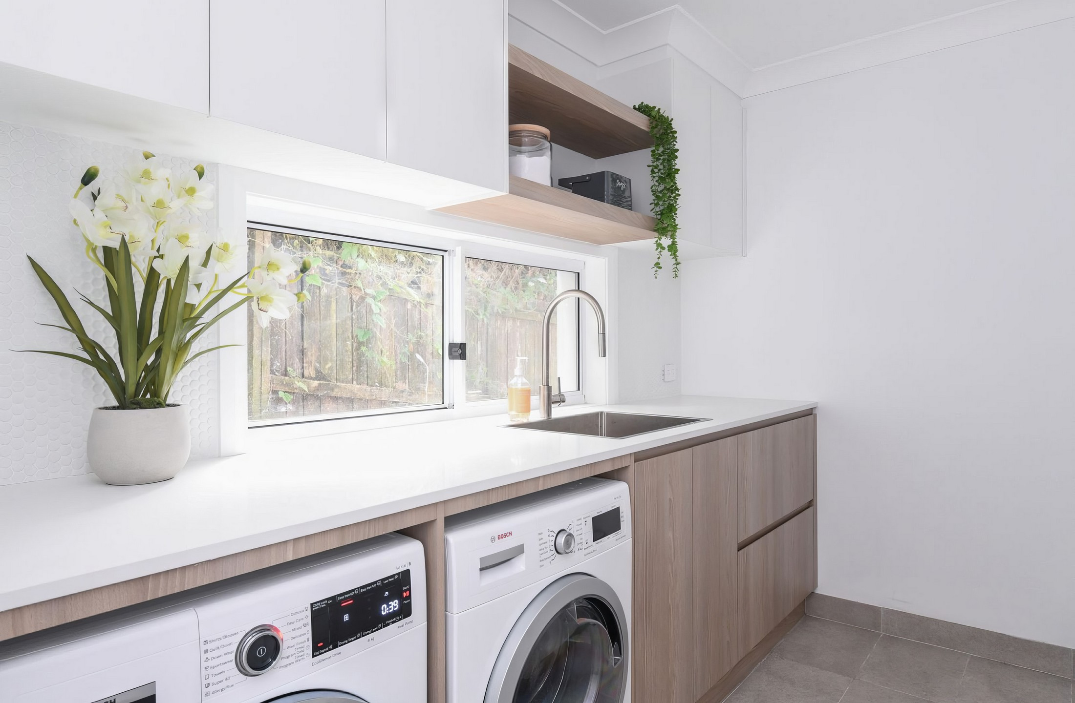 Laundry room renovation with custom cabinetry and white countertops